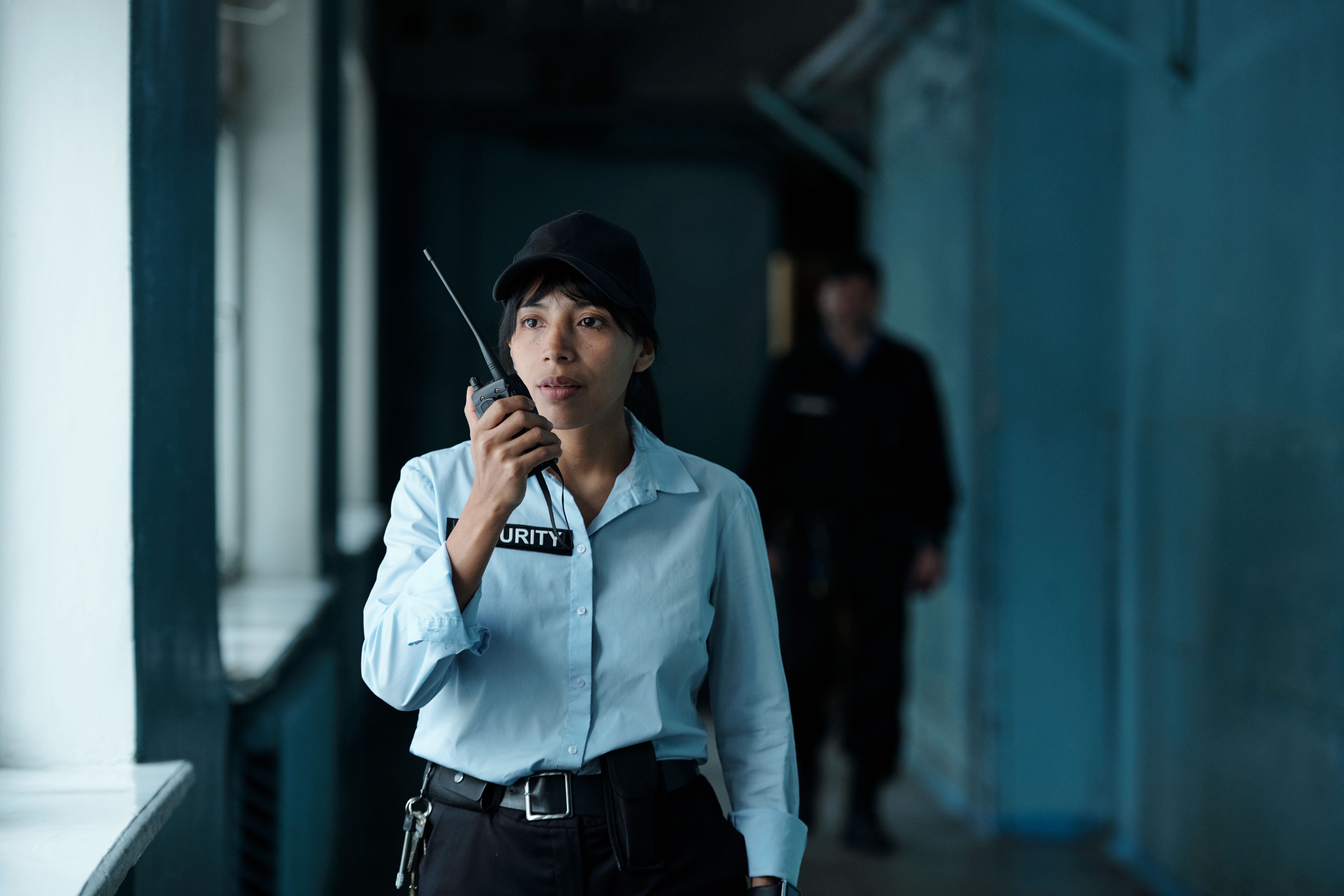 Female guard speaking on walkie-talkie